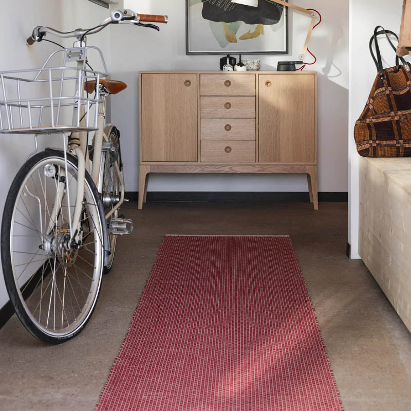 NILS Dark Red Runner Rug by Pappelina, showing nils dark red runner rug in live shot.