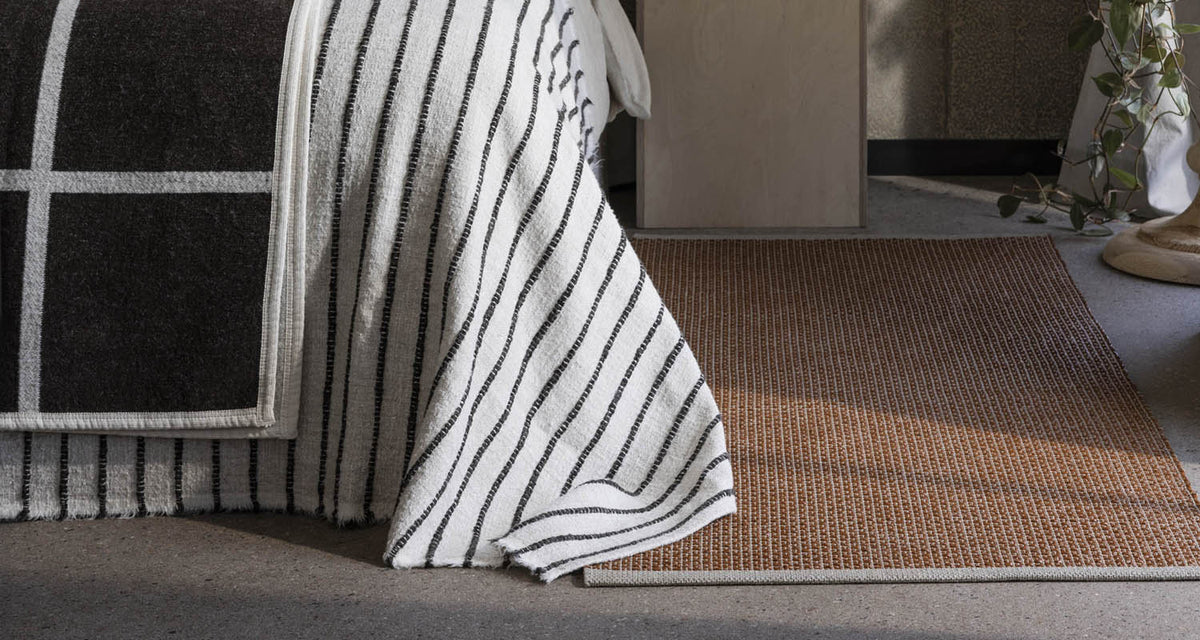NILS Rust Runner Rug by Pappelina, showing nils rust runner rug in live shot.