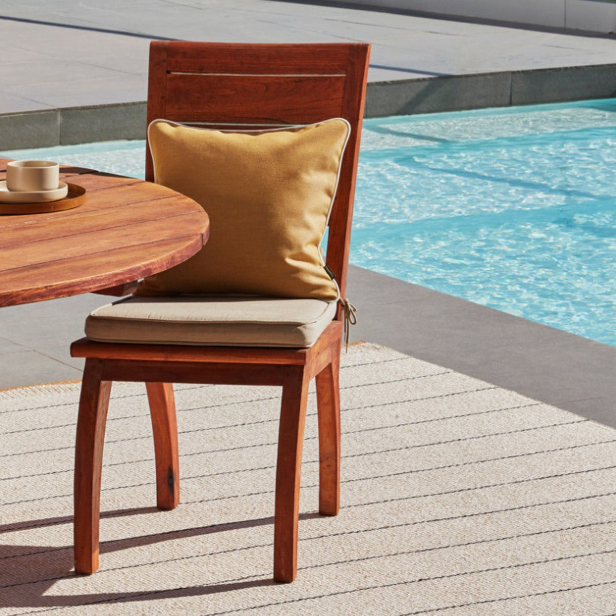 Sunny Amber Indoor & Outdoor Cushion by Pappelina, showing sunny amber indoor & outdoor cushion in live shot.