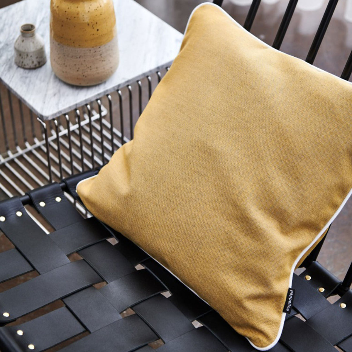 Sunny Amber Indoor & Outdoor Cushion by Pappelina, showing sunny amber indoor & outdoor cushion in live shot.