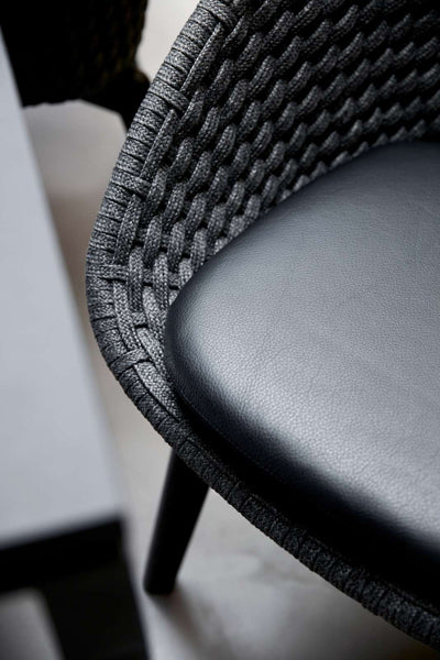Peacock Indoor Dining Chair by Cane-Line, showing closeup view of peacock indoor dining chair in live shot.