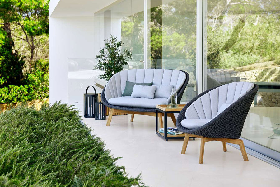 Peacock Outdoor 2-Seater Sofa by Cane-Line, showing peacock outdoor 2-seater sofa in live shot.