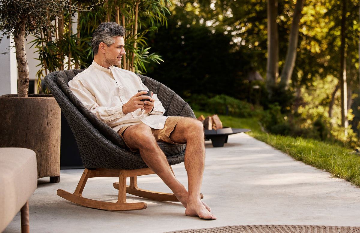 Peacock Outdoor Rocking Chair by Cane-Line, showing peacock outdoor rocking chair in live shot.