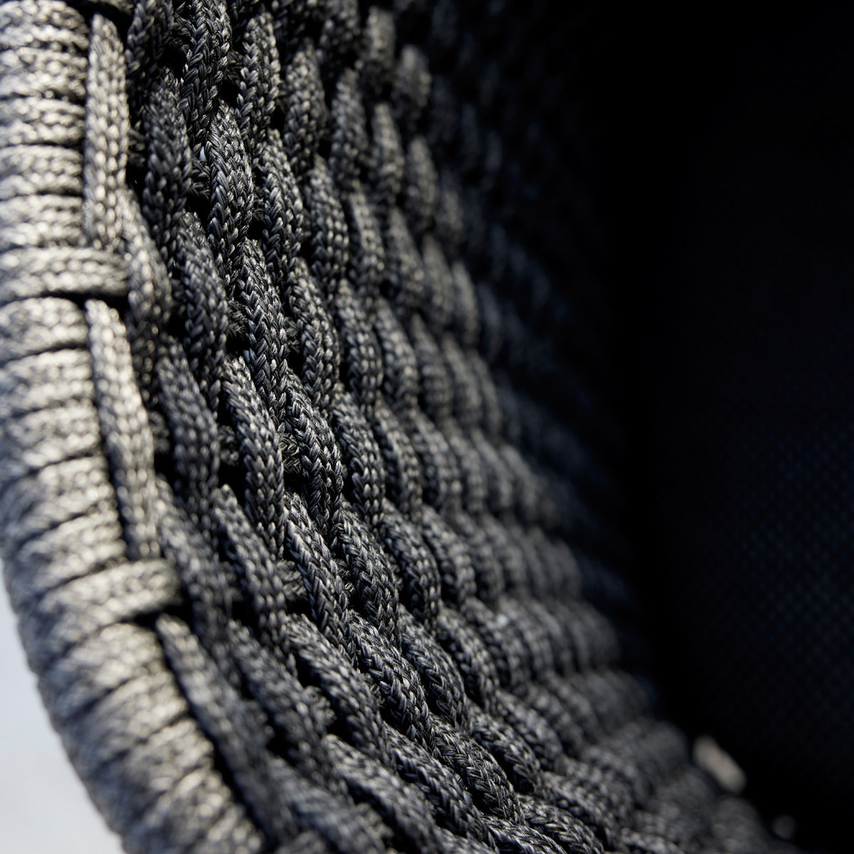 Peacock Outdoor Rocking Chair by Cane-Line, showing closeup view of peacock outdoor rocking chair in live shot.