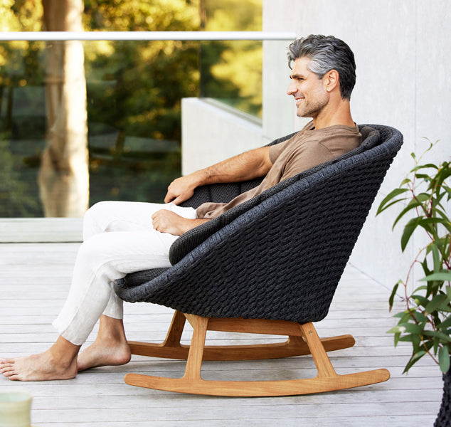 Peacock Outdoor Rocking Chair by Cane-Line, showing peacock outdoor rocking chair in live shot.