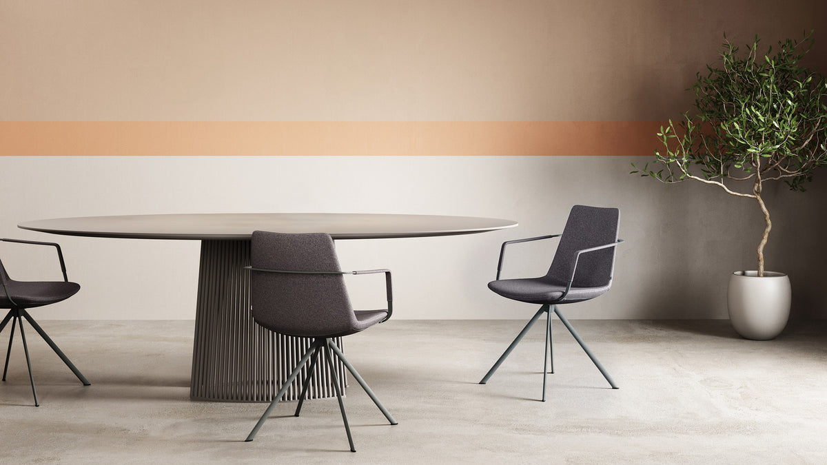 Pera Ellipse Swivel Armchair by B&T, showing pera ellipse swivel armchairs in live shot.
