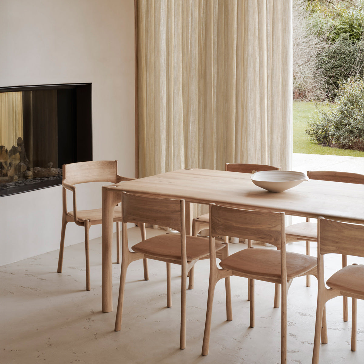 PI Dining Chair by Ethnicraft, showing pi dining chairs in live shot.