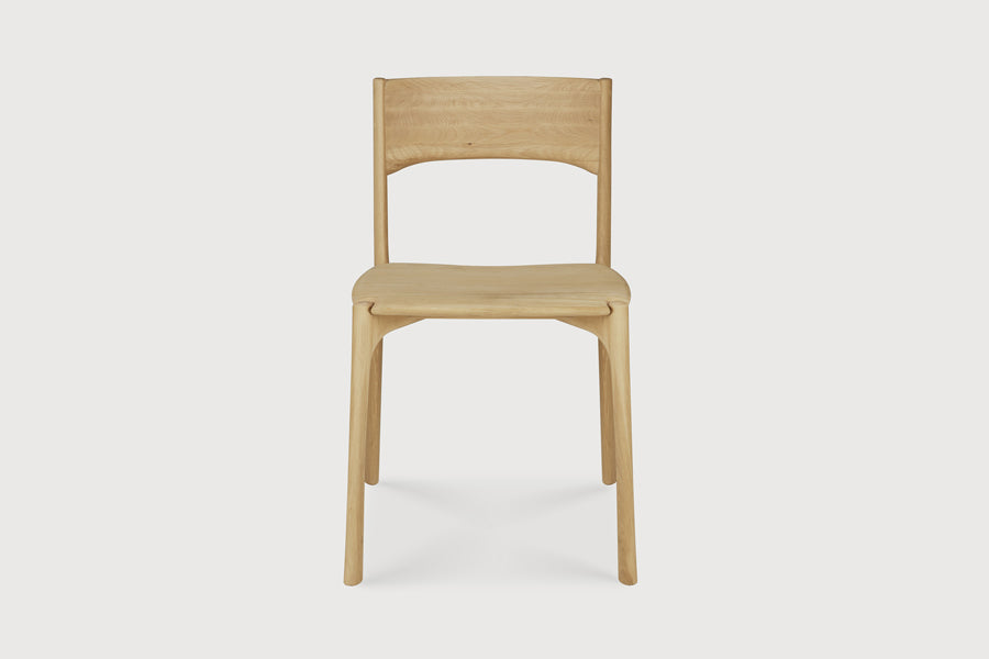 PI Dining Chair by Ethnicraft, showing front view of pi dining chair in live shot.