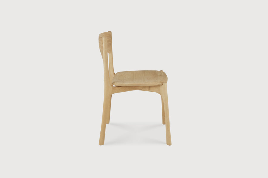PI Dining Chair by Ethnicraft, showing side view of pi dining chair in live shot.