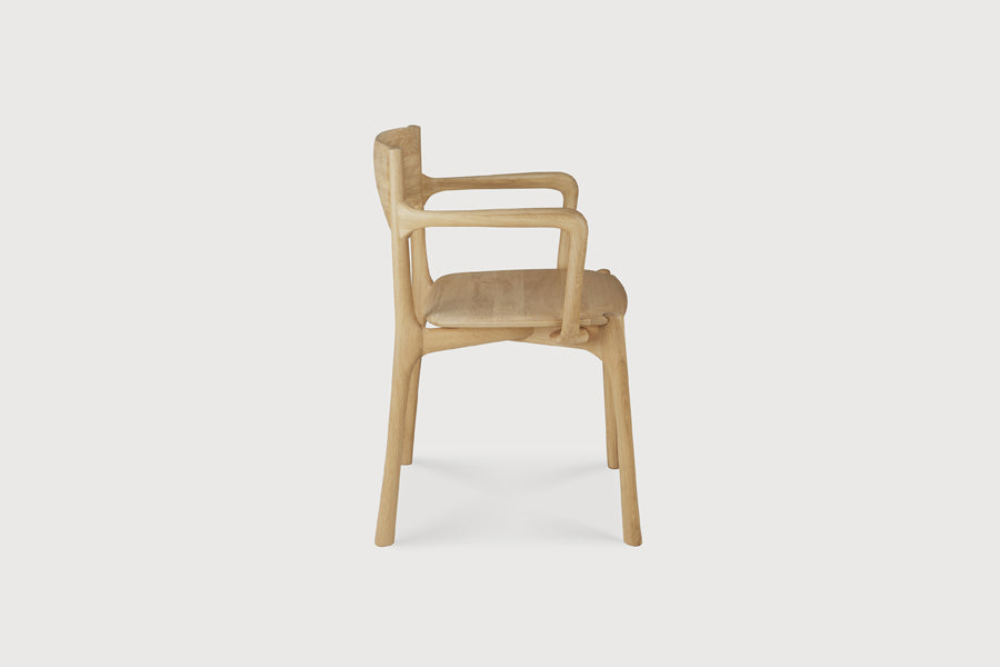 PI Dining Chair by Ethnicraft, showing side view of pi dining chair in live shot.