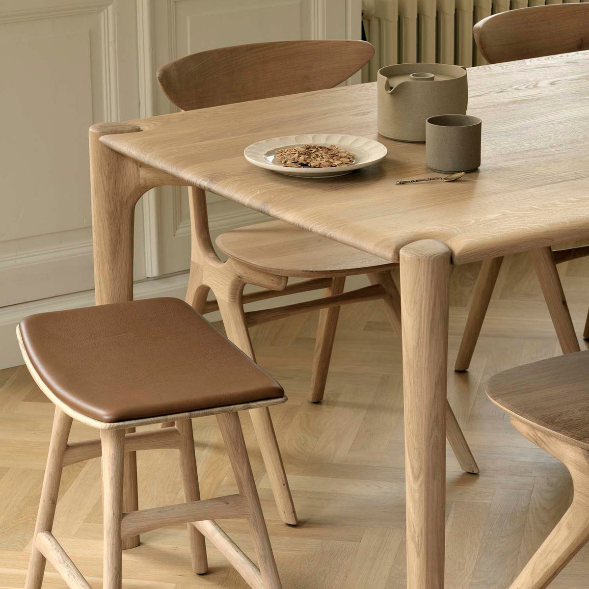 PI Dining Table by Ethnicraft, showing closeup view of pi dining table in live shot.