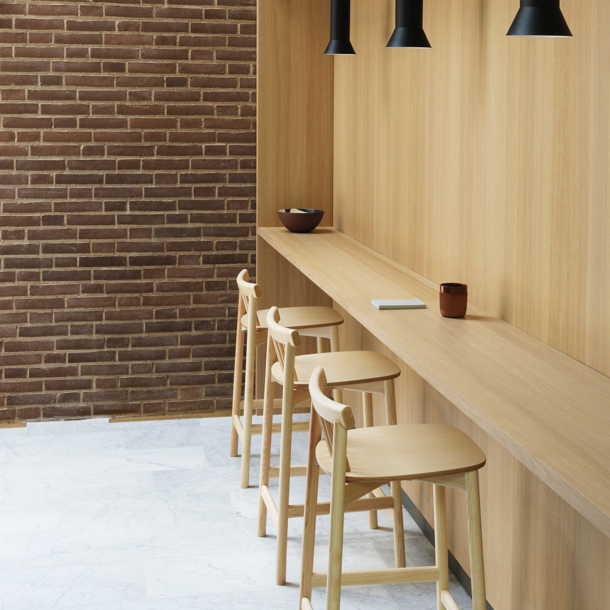 Pind Barstool by Normann Copenhagen, showing pind barstools in live shot.