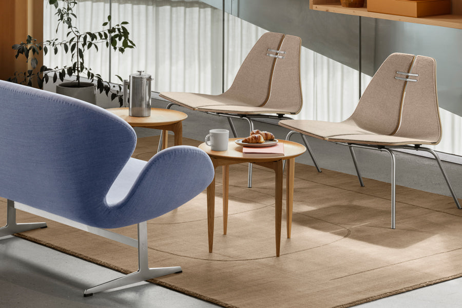 PK23 Lounge Chair by Fritz Hansen, showing pk23 lounge chairs in live shot.