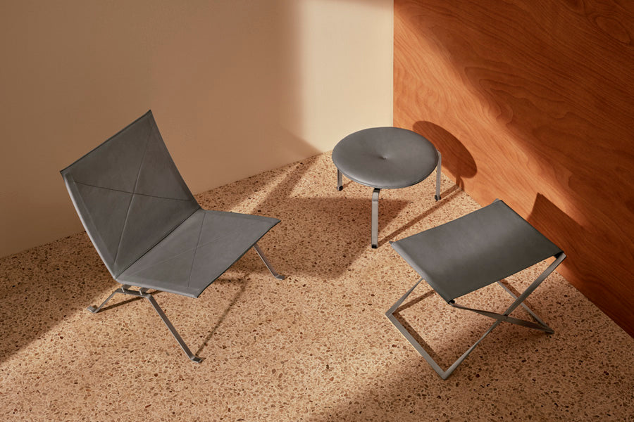 PK91 Folding Stool by Fritz Hansen, showing pk91 folding stool in live shot.