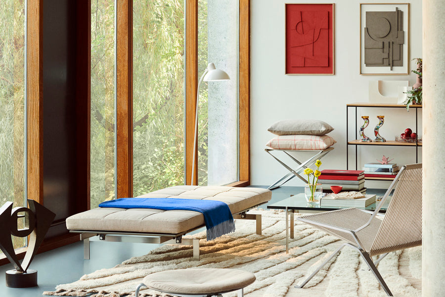PK91 Folding Stool by Fritz Hansen, showing pk91 folding stool in live shot.