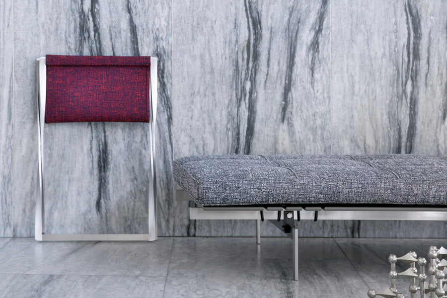 PK91 Folding Stool by Fritz Hansen, showing pk91 folding stool in live shot.