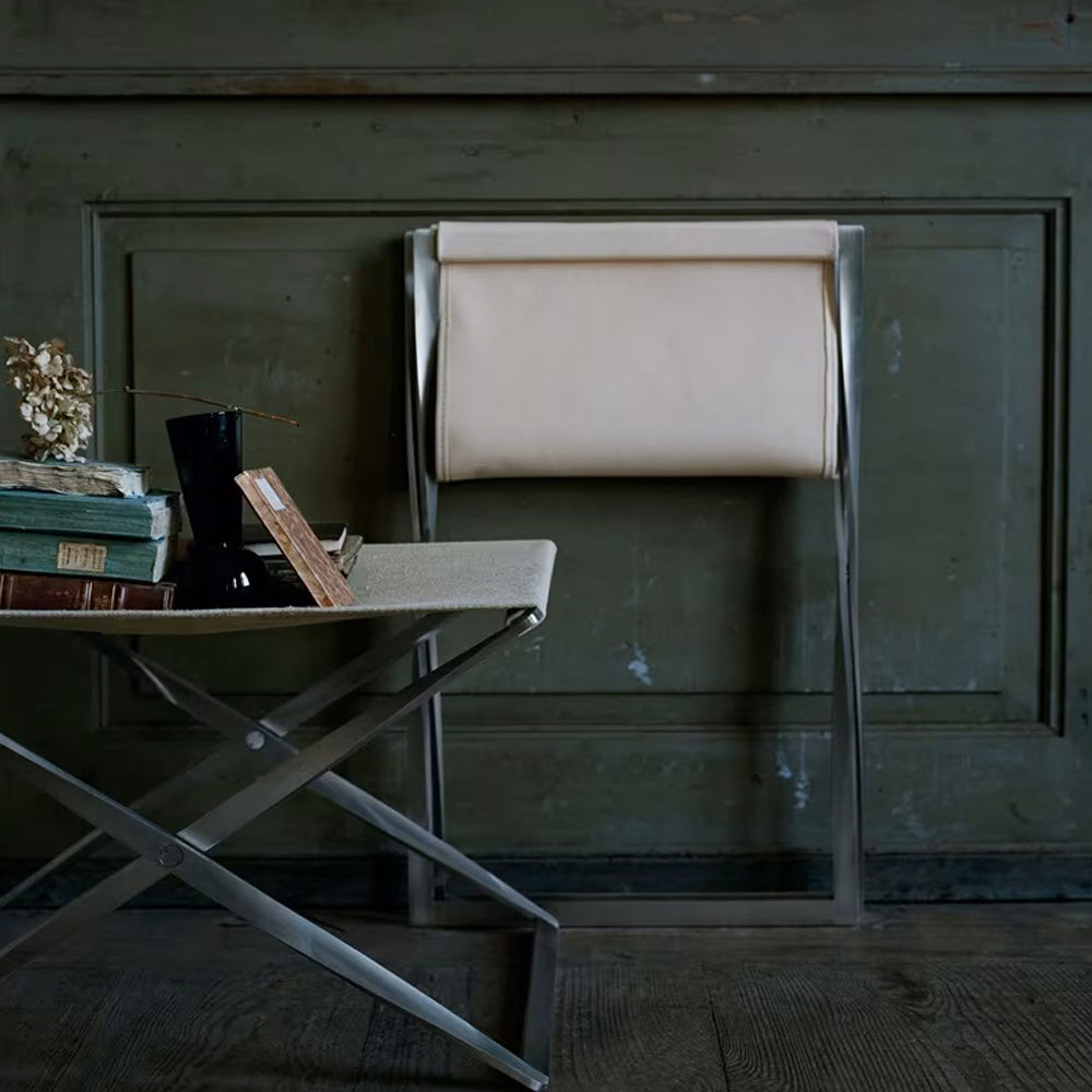 PK91 Folding Stool by Fritz Hansen, showing pk91 folding stool in live shot.