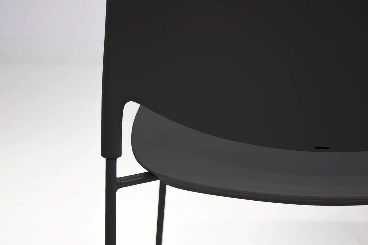 Pringle Stackable Dining Chair by Mobital, showing closeup view of pringle stckable dining chair in live shot.
