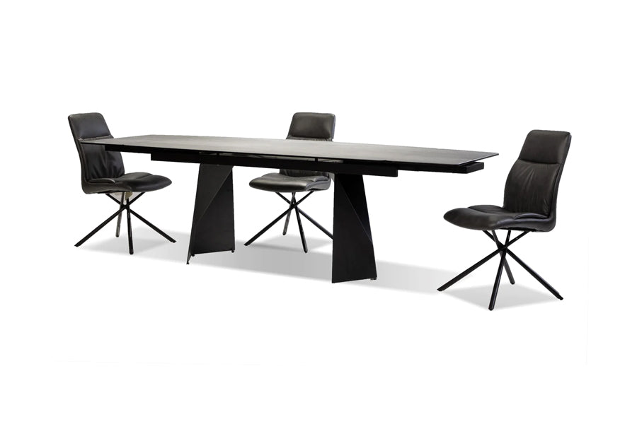 Prism Extending Dining Table by Mobital, showing angle view of prism extending dining table in industrial grey ceramic/black powder coated with chairs.