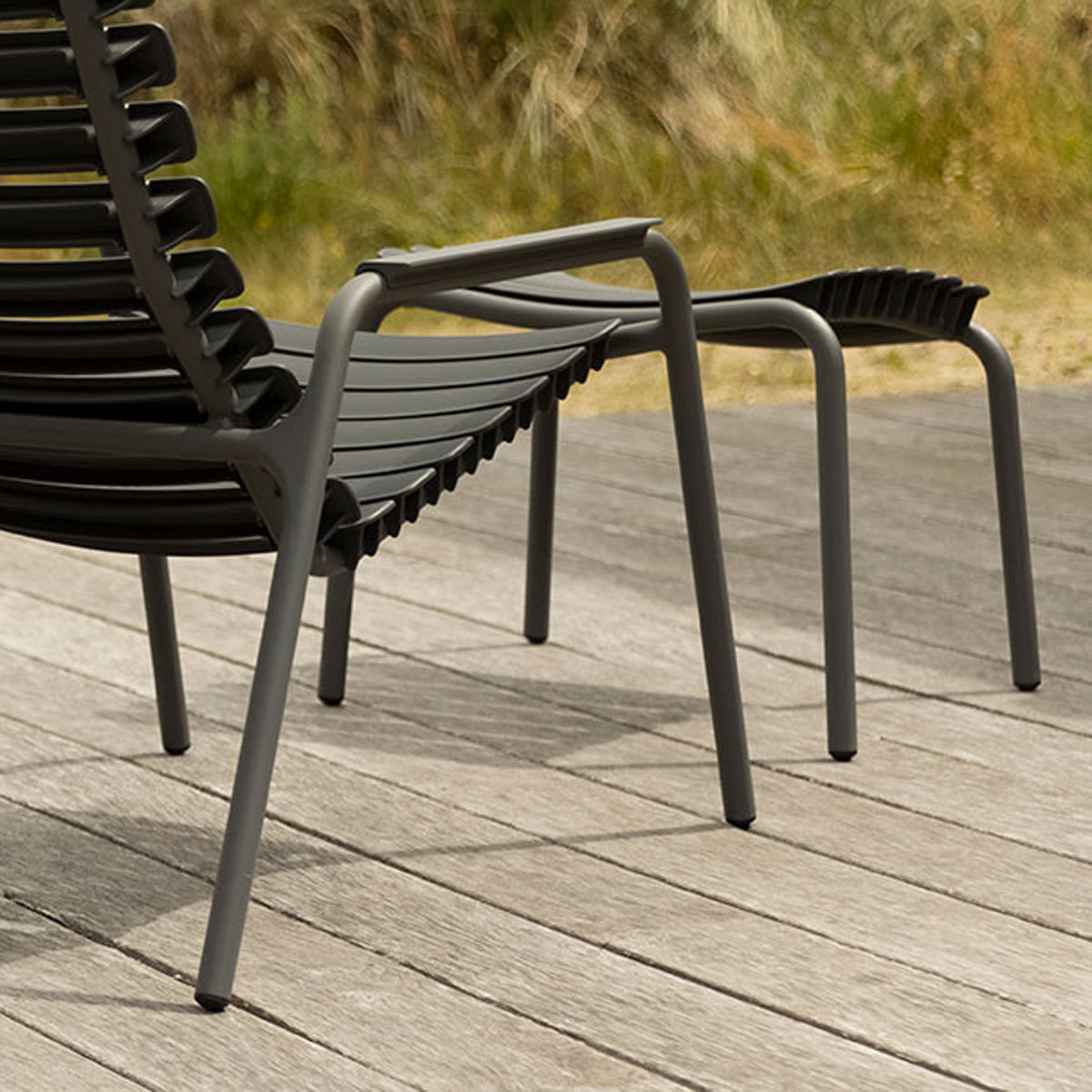 Reclips Outdoor Lounge Chair by Houe, showing closeup view of reclips outdoor lounge chair in live shot.