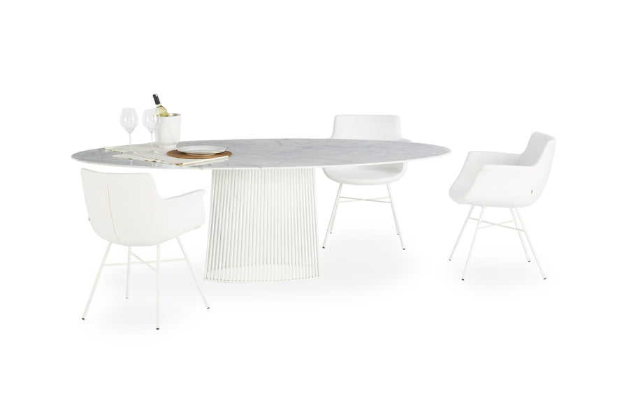 Rego X Chair by B&T, showing rego x chairs in white bugatti eco-leather + white base with table.