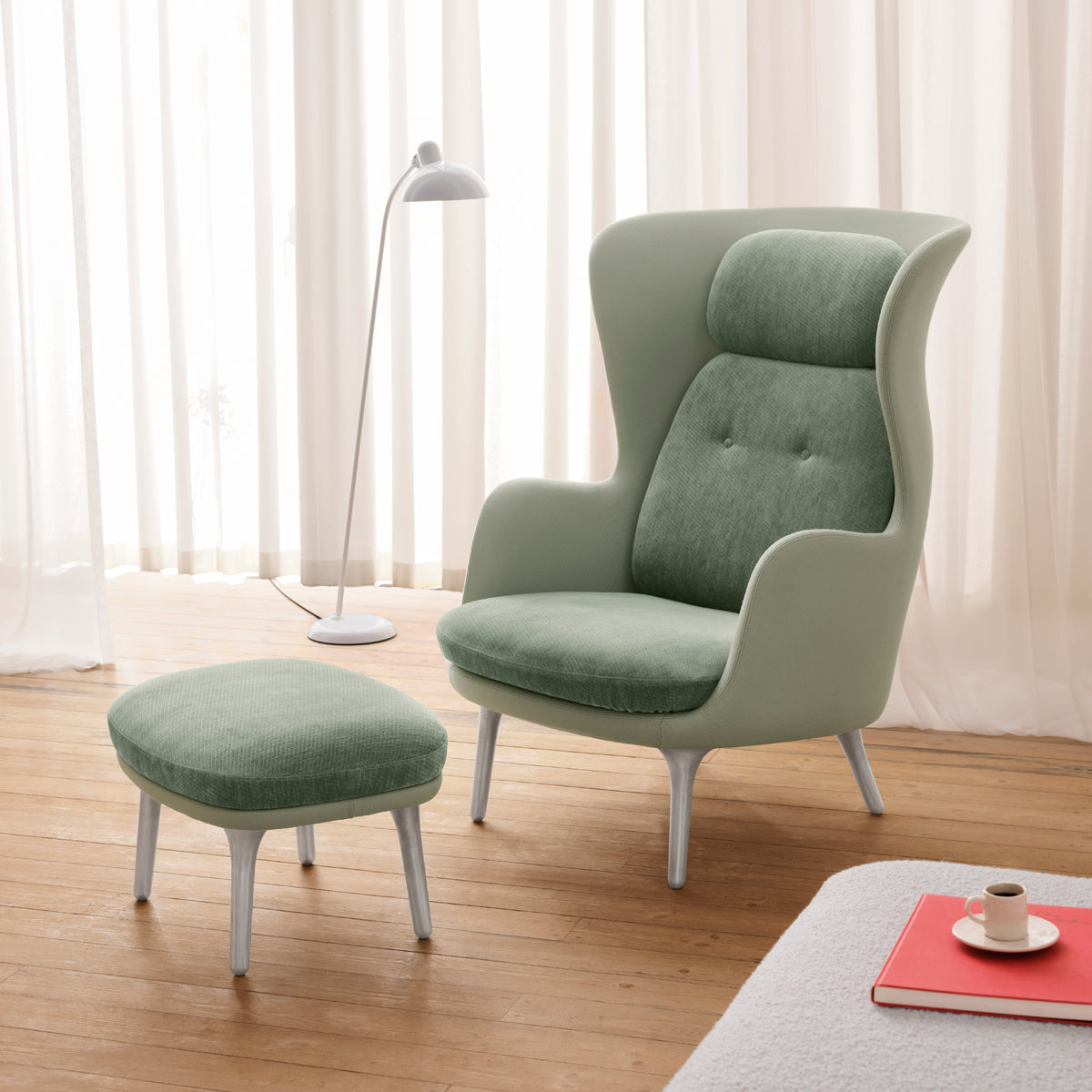 Ro Footstool by Fritz Hansen, showing ro footstool in live shot.
