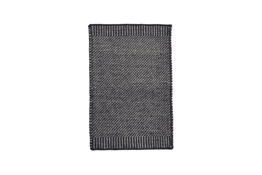Rombo Mat by Woud, showing front view of rombo mat in small/grey woven wool.