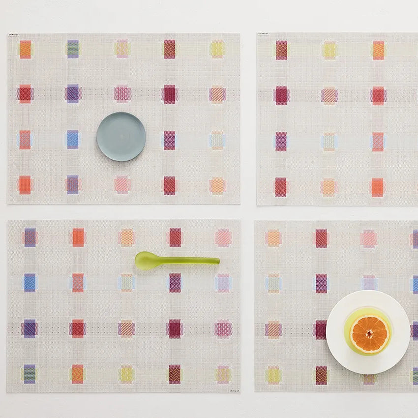 Sampler Tabletop by Chilewich, showing closeup view of sampler tabletops in live shot.