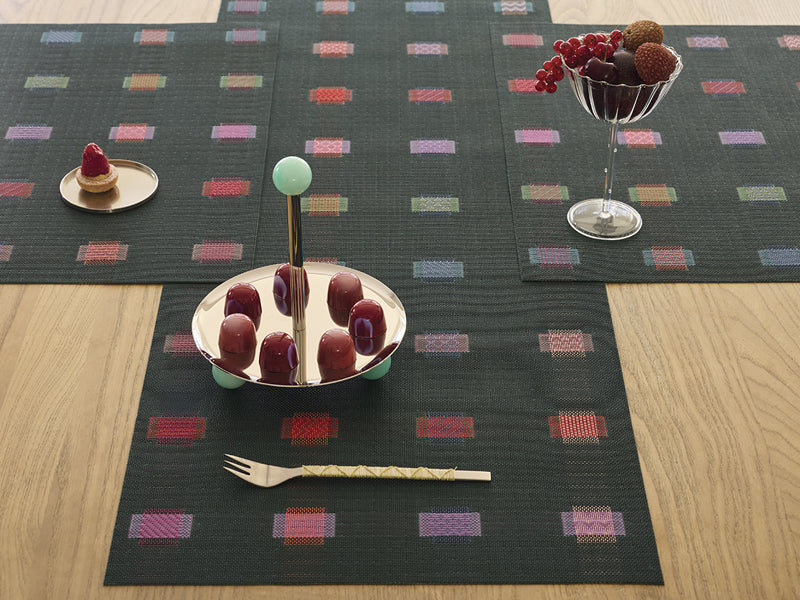 Sampler Tabletop by Chilewich, showing closeup view of sampler tabletops in live shot.