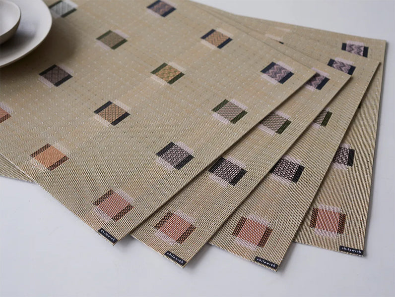 Sampler Tabletop by Chilewich, showing closeup view of sampler tabletops in live shot.