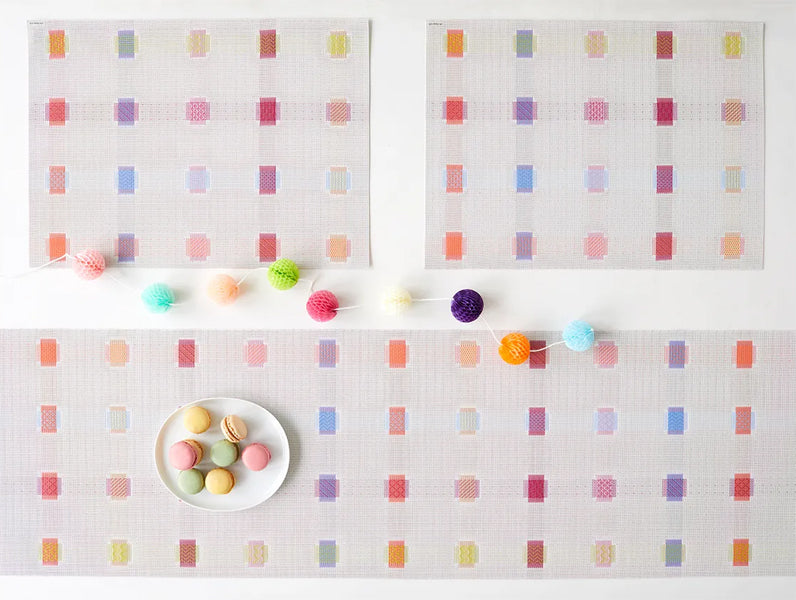 Sampler Tabletop by Chilewich, showing closeup view of sampler tabletops in live shot.