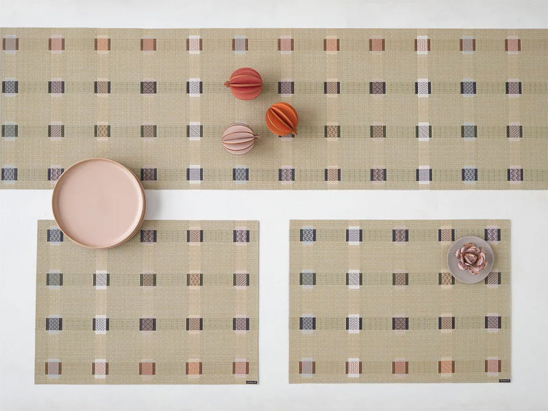 Sampler Tabletop by Chilewich, showing closeup view of sampler tabletops in live shot.