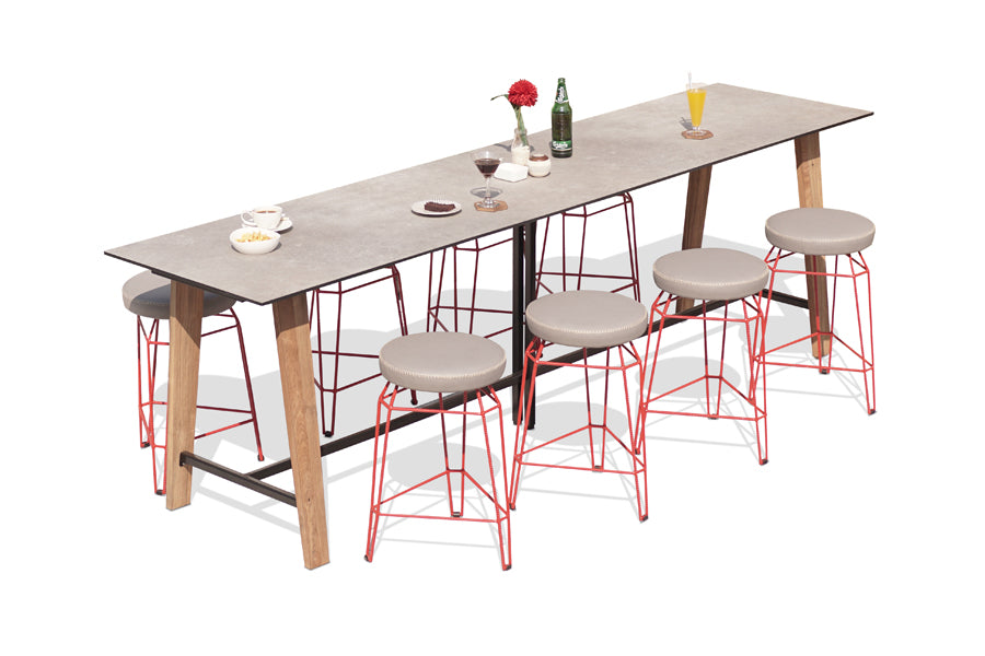 Sato Communal Table by Mamagreen, showing angle view of sato communal table in laterite HPL/rustic recycled teak wood with stools.