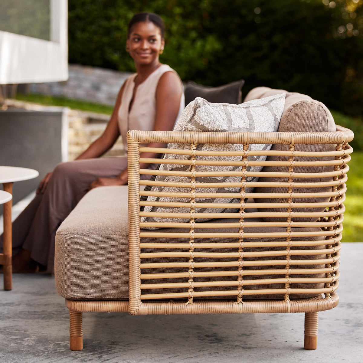 Sense Outdoor 3-Seater Sofa by Cane-Line, showing sense outdoor 3-seater sofa in live shot.