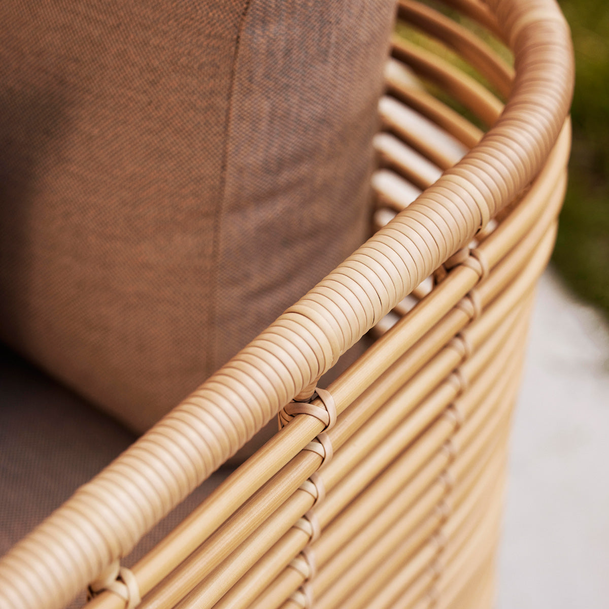 Sense Outdoor 3-Seater Sofa by Cane-Line, showing closeup view of sense outdoor 3-seater sofa in live shot.