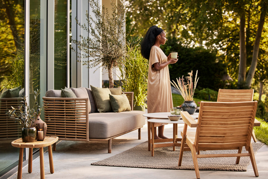 Sense Outdoor 3-Seater Sofa by Cane-Line, showing sense outdoor 3-seater sofa in live shot.
