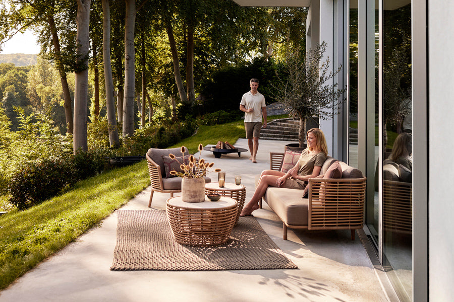 Sense Outdoor 3-Seater Sofa by Cane-Line, showing sense outdoor 3-seater sofa in live shot.