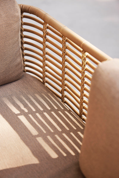 Sense Outdoor 3-Seater Sofa by Cane-Line, showing closeup view of sense outdoor 3-seater sofa in live shot.