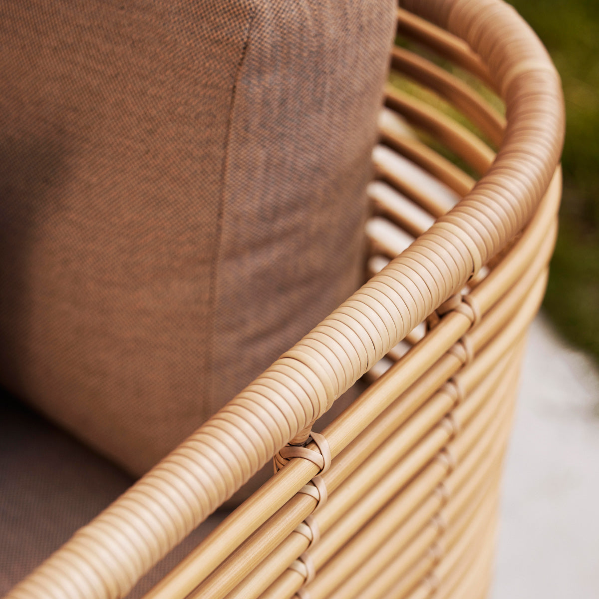 Sense Outdoor Lounge Chair by Cane-Line, showing closeup view of sense outdoor lounge chair in live shot.