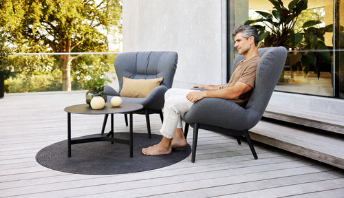 Serene Lounge Chair by Cane-Line, showing serene lounge chairs in live shot.