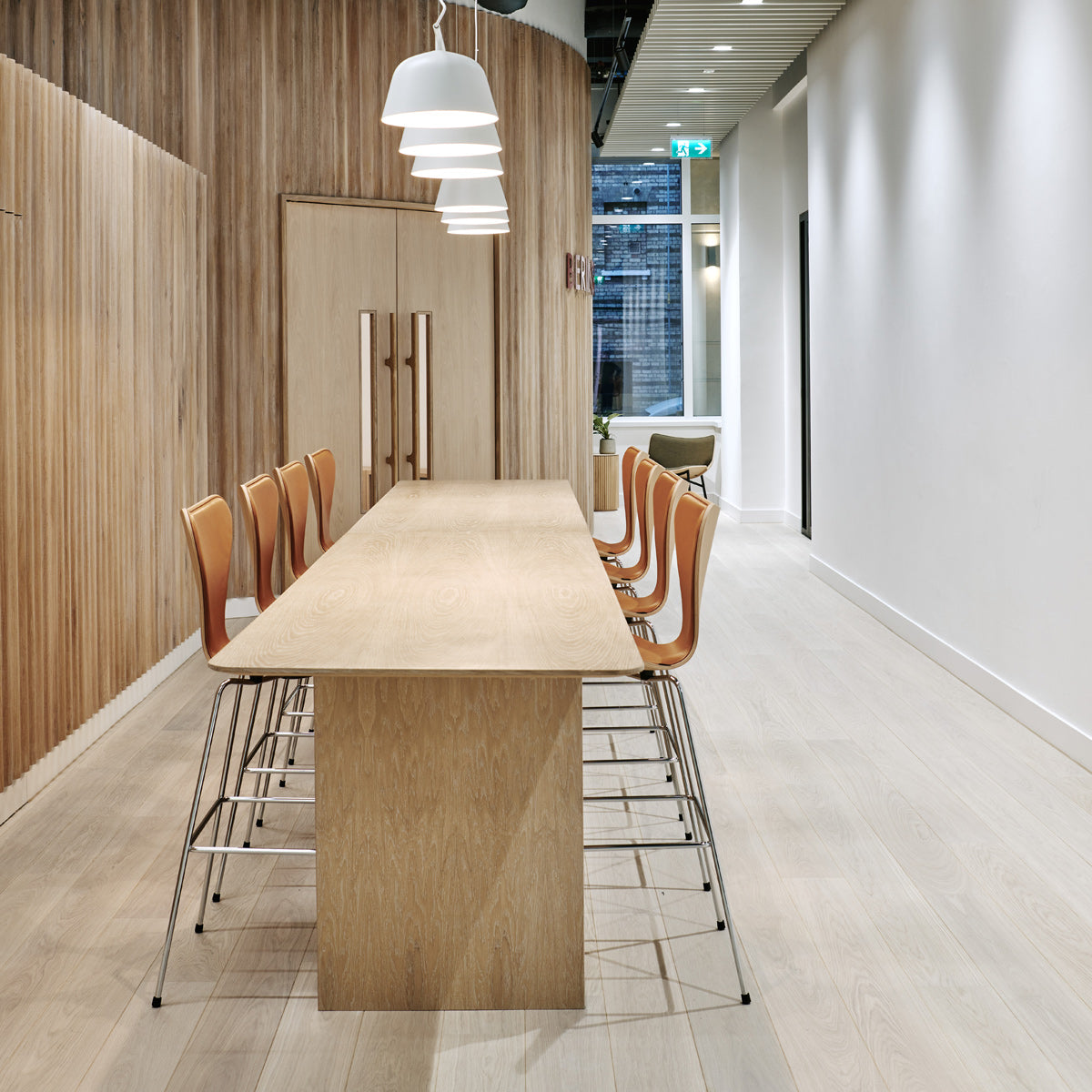 Series 7 Front Upholstery Stool by Fritz Hansen, showing series 7 front upholstery stools in live shot.