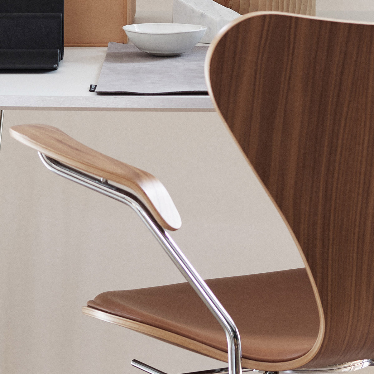Series 7 Front Upholstery Swivel Armchair by Fritz Hansen, showing closeup view of series 7 front upholstery swivel armchair in live shot.