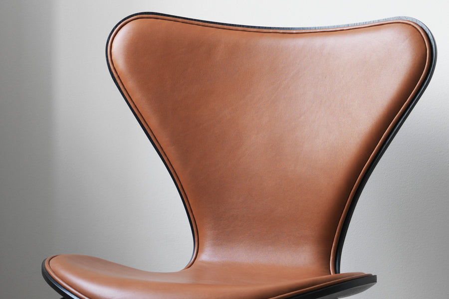 Series 7 Front Upholstery Swivel Chair by Fritz Hansen, showing closeup view of series 7 front upholstery swivel chair in live shot.