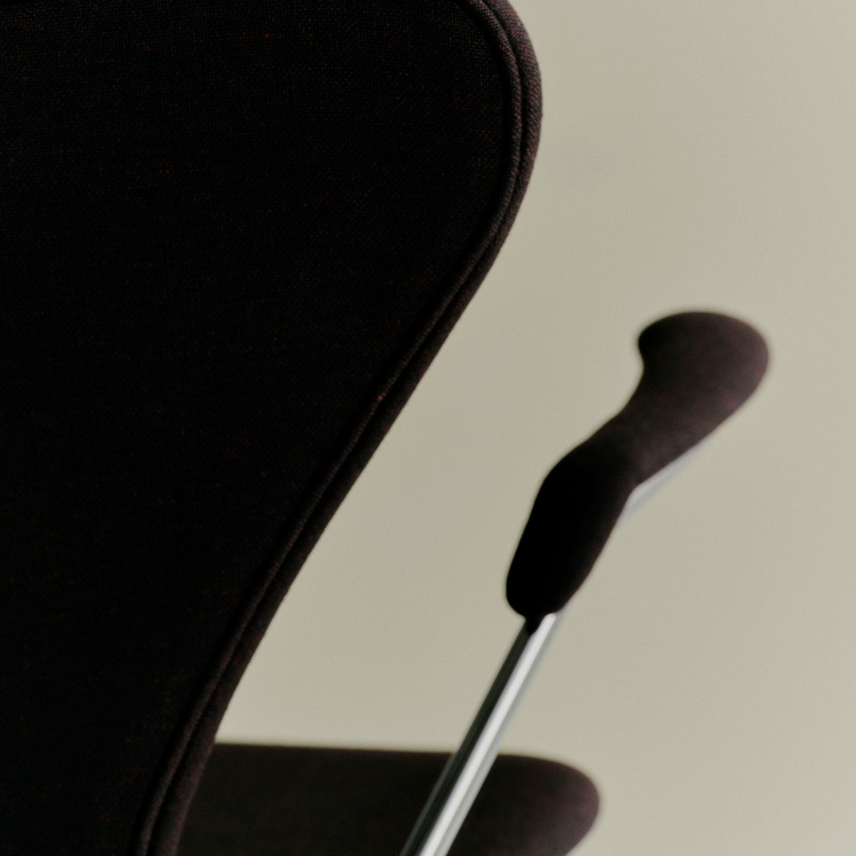 Series 7 Full Upholstery Armchair by Fritz Hansen, showing closeup view of series 7 full upholstery armchair in live shot.