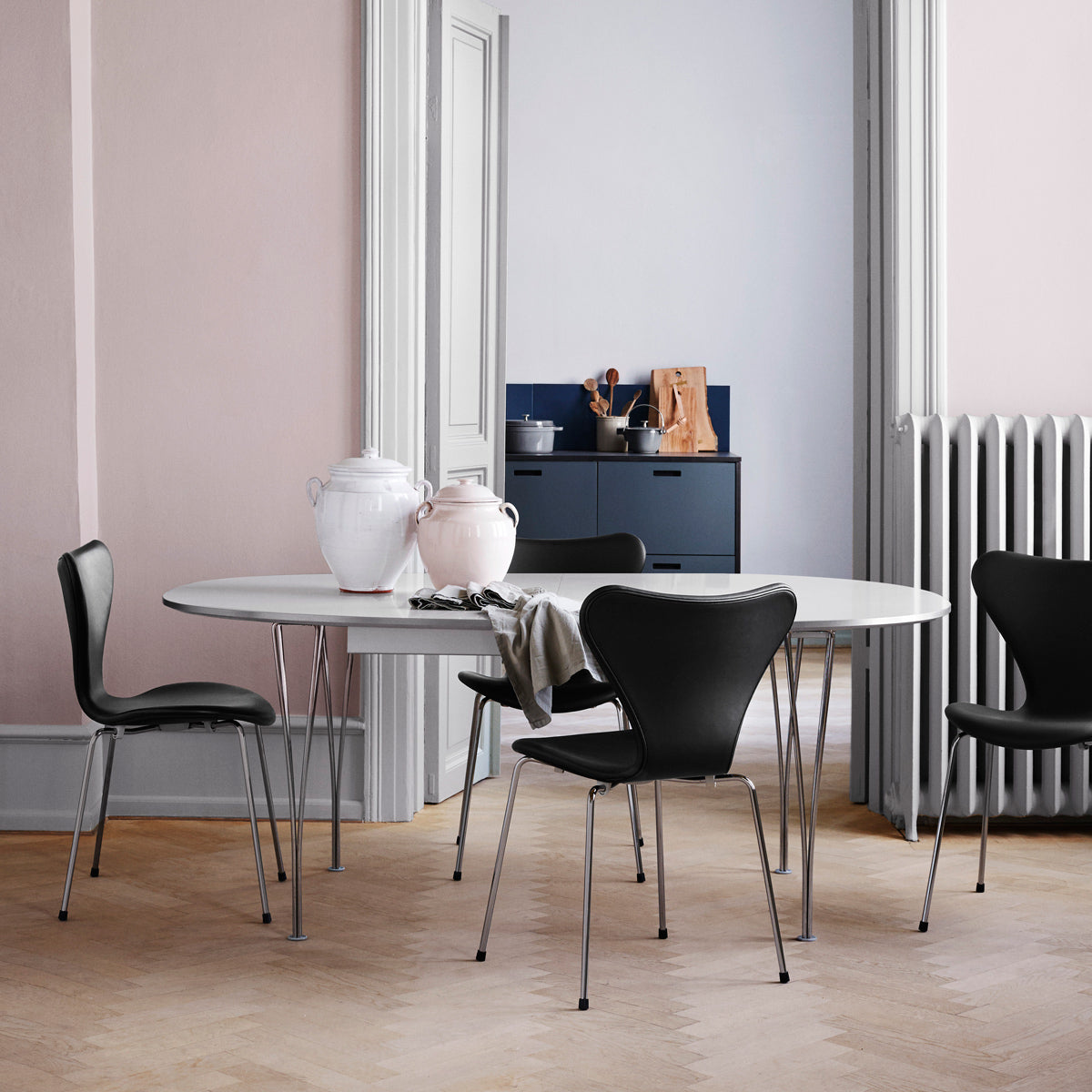 Series 7 Full Upholstery Chair by Fritz Hansen, showing series 7 full upholstery chairs in live shot.