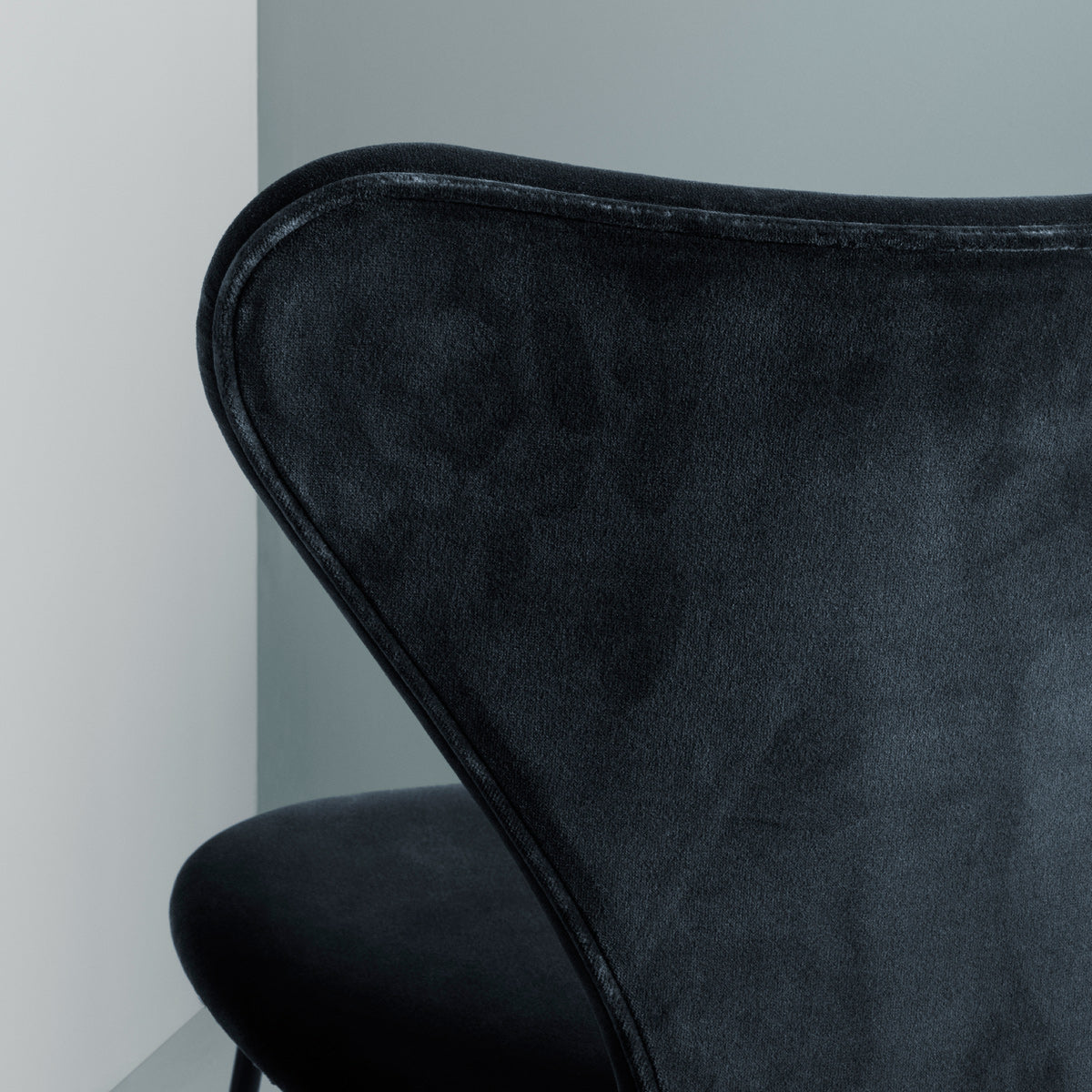 Series 7 Full Upholstery Stool by Fritz Hansen, showing closeup view of series 7 full upholstery stool in live shot.