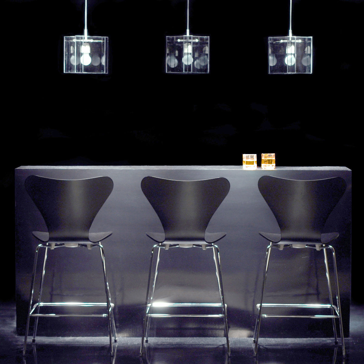 Series 7 Stool by Fritz Hansen, showing series 7 stools in live shot.