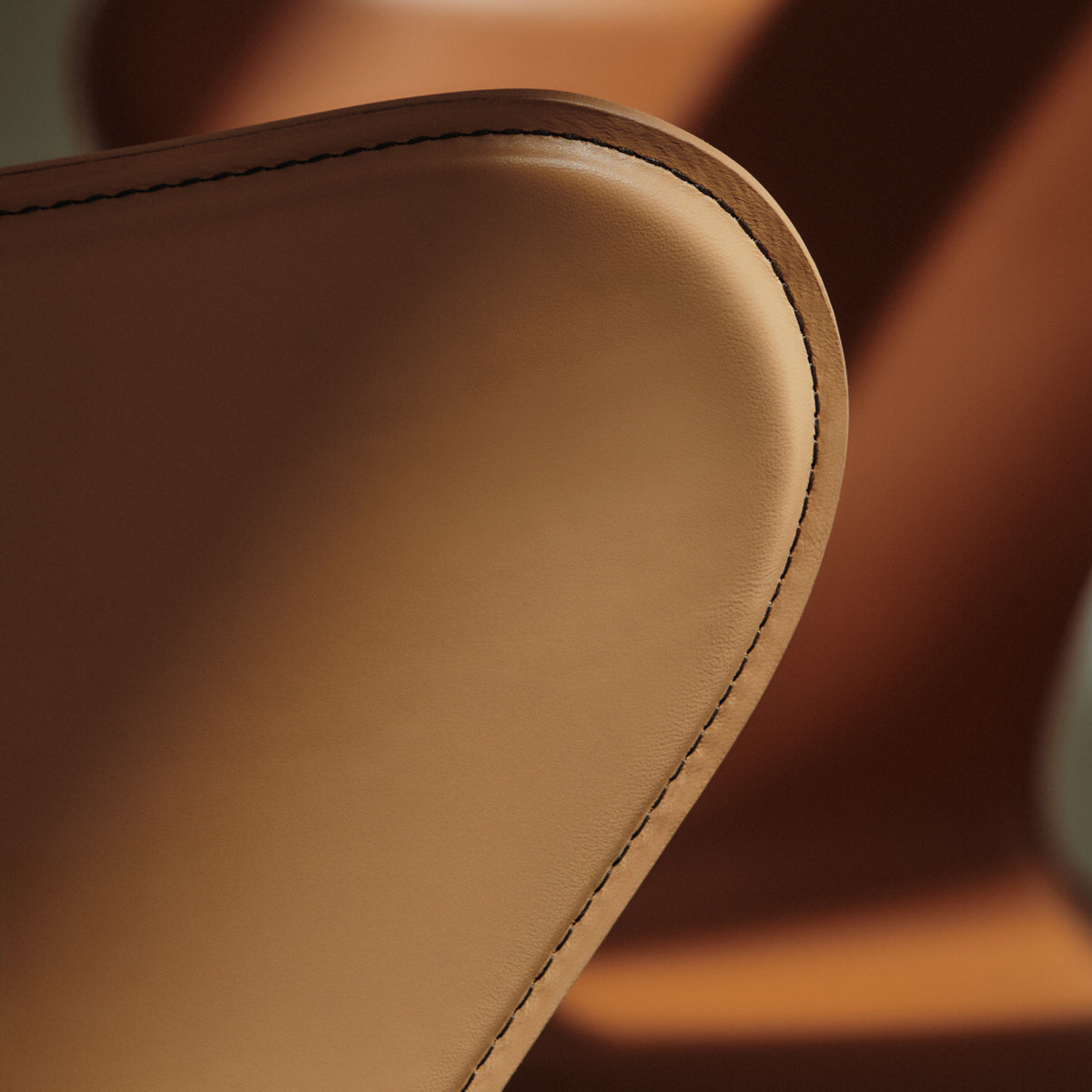 Series 7 Swivel Armchair by Fritz Hansen, showing closeup view of series 7 swivel armchair in live shot.