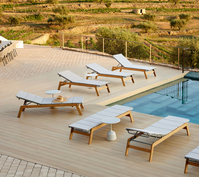 Siesta Sunbed by Cane-Line, showing siesta sunbeds in live shot.