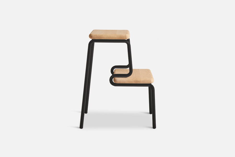 Slalom Step Stool by Woud, showing side view of slalom step stool in live shot.
